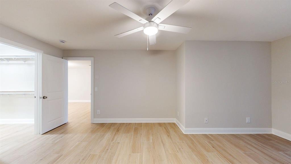 636 Boca Ciega Point Boulevard South St. Petersburg, FL 33708 - Photo 42 of 96 an empty room with wooden floor and fan