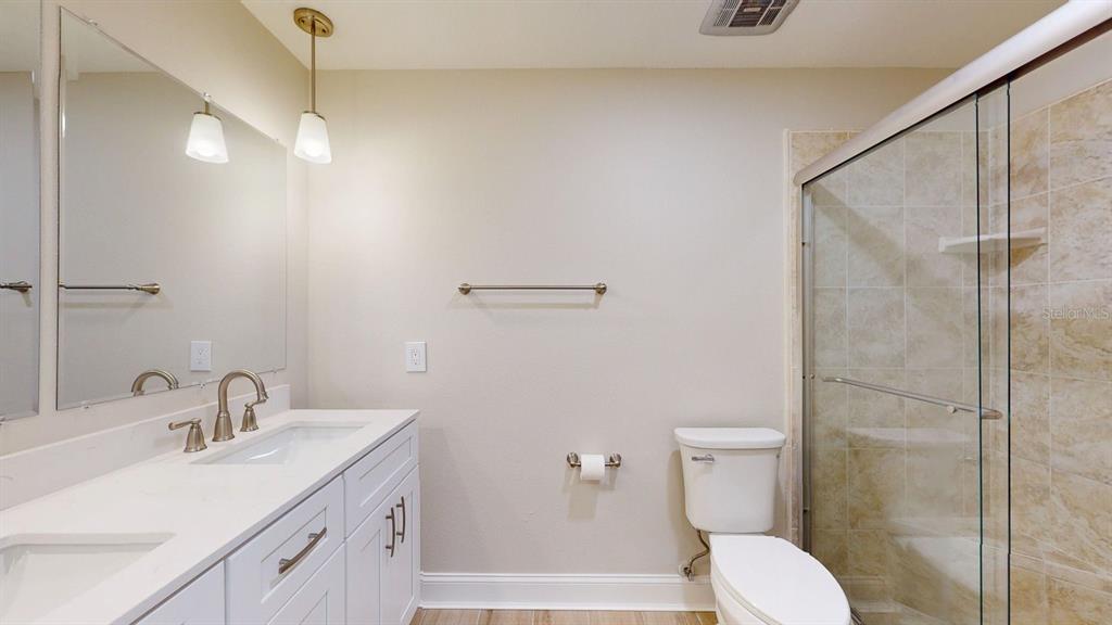 636 Boca Ciega Point Boulevard South St. Petersburg, FL 33708 - Photo 46 of 96 a bathroom with a sink toilet and shower