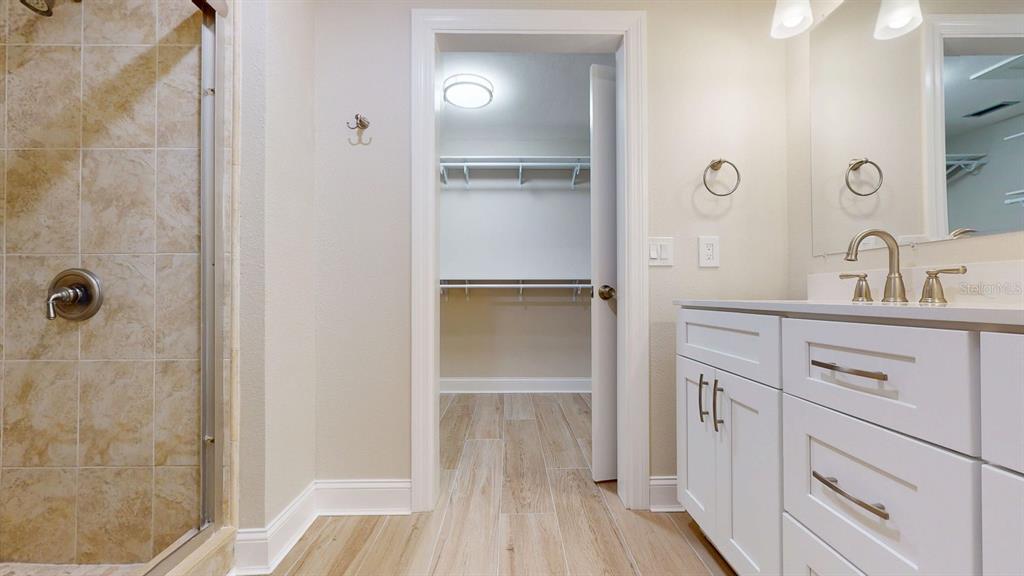 636 Boca Ciega Point Boulevard South St. Petersburg, FL 33708 - Photo 49 of 96 a bathroom with a double vanity sink and mirror