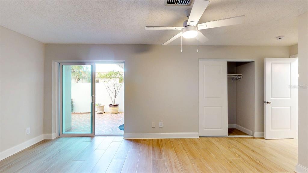 636 Boca Ciega Point Boulevard South St. Petersburg, FL 33708 - Photo 57 of 96 a view of an empty room with wooden floor and a window