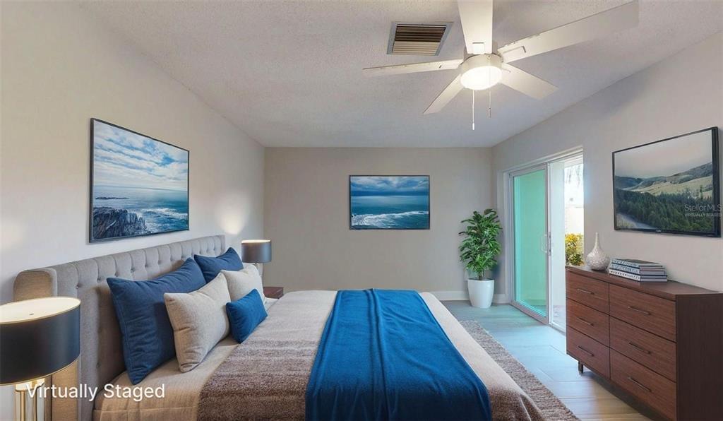 636 Boca Ciega Point Boulevard South St. Petersburg, FL 33708 - Photo 59 of 96 a bedroom with a bed and a flat screen tv