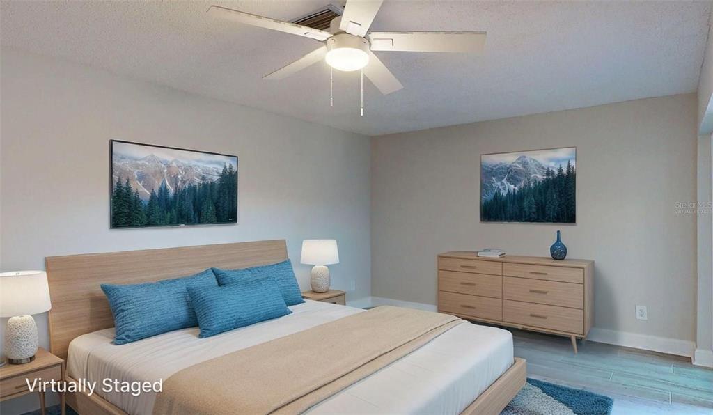 636 Boca Ciega Point Boulevard South St. Petersburg, FL 33708 - Photo 61 of 96 a bedroom with a bed and a chandelier