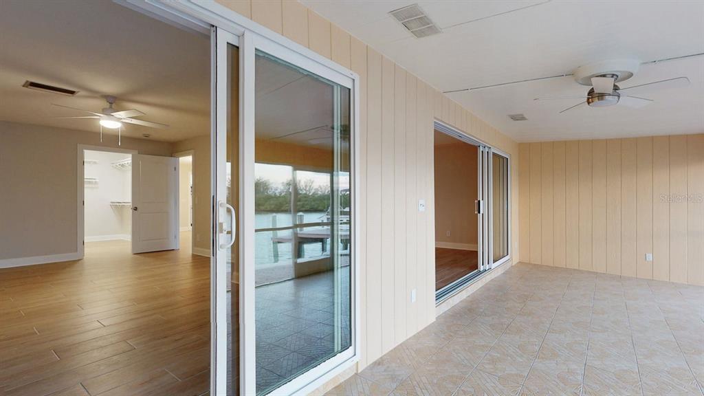636 Boca Ciega Point Boulevard South St. Petersburg, FL 33708 - Photo 79 of 96 a view of a hallway view with wooden floor and glass door
