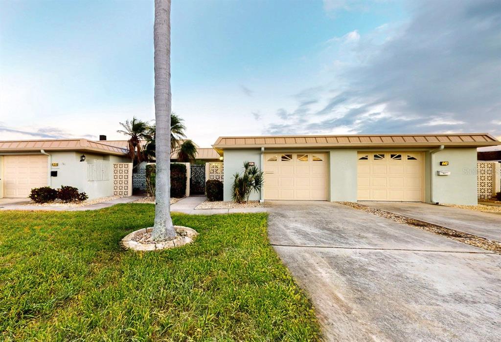 636 Boca Ciega Point Boulevard South St. Petersburg, FL 33708 - Photo 8 of 96 a front view of a house with a yard