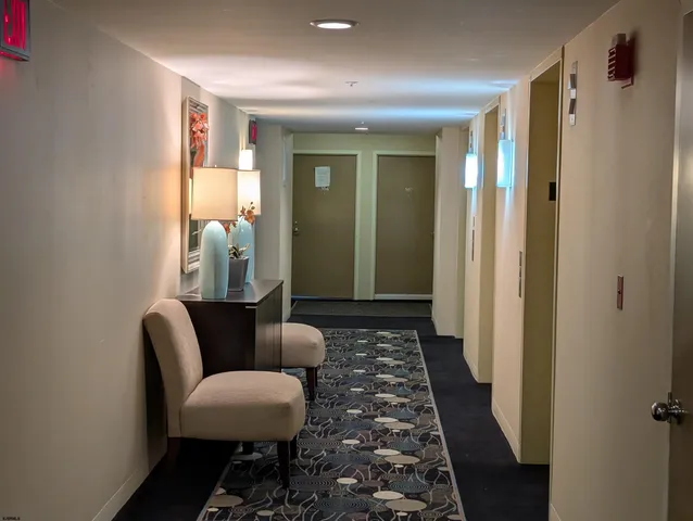 a utility room with dryer washer and empty racks