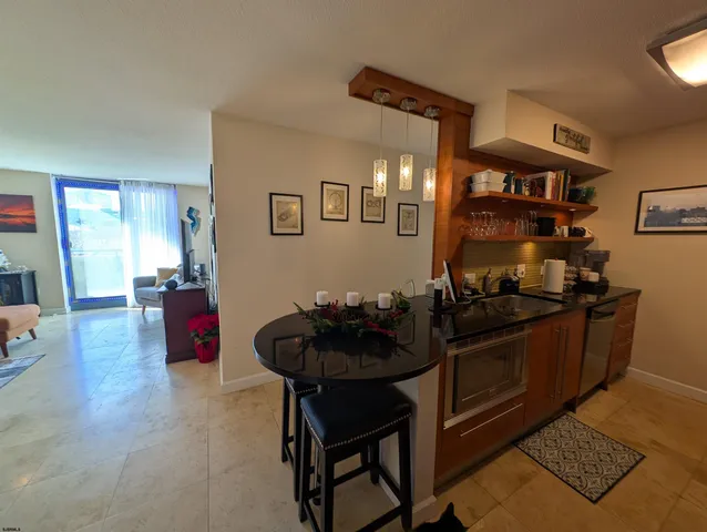 a kitchen with stainless steel appliances a stove a chimney a sink and a refrigerator