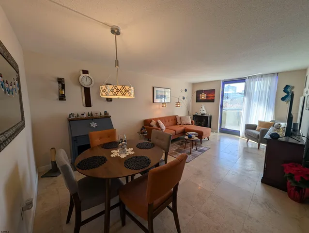 a dining room with furniture and window