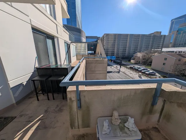 a view of a house with wooden deck and furniture