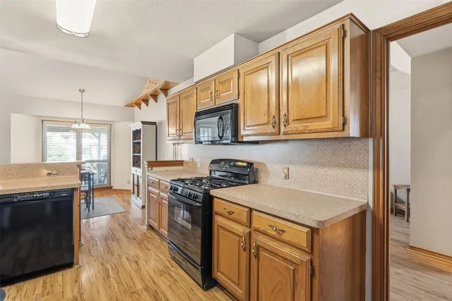 a kitchen with stainless steel appliances granite countertop a stove and a sink