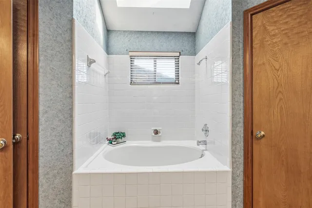 a white bath tub sitting next to a white sink