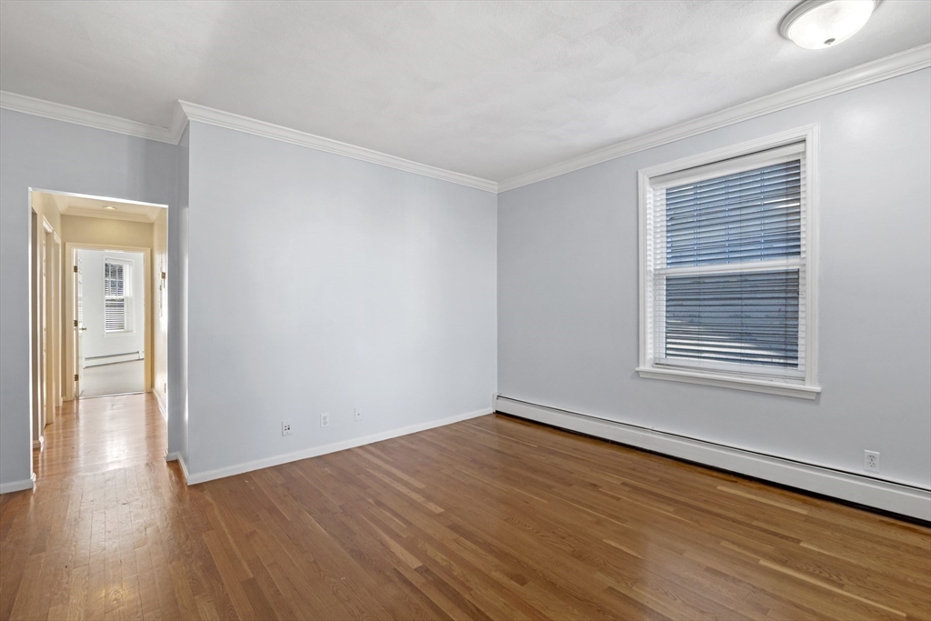 42 Broad Street, Unit 4 Salem, MA 01970 - Photo 5 of 33 a view of an empty room with wooden floor and a window