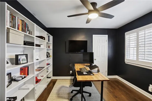 a bedroom with furniture and a large window
