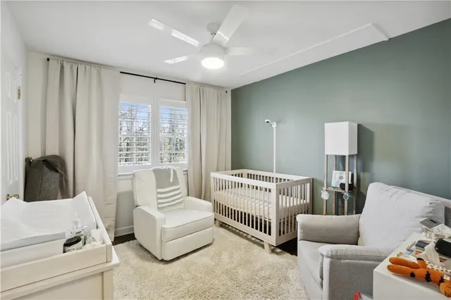 a room with a baby crib cabinets and a couch