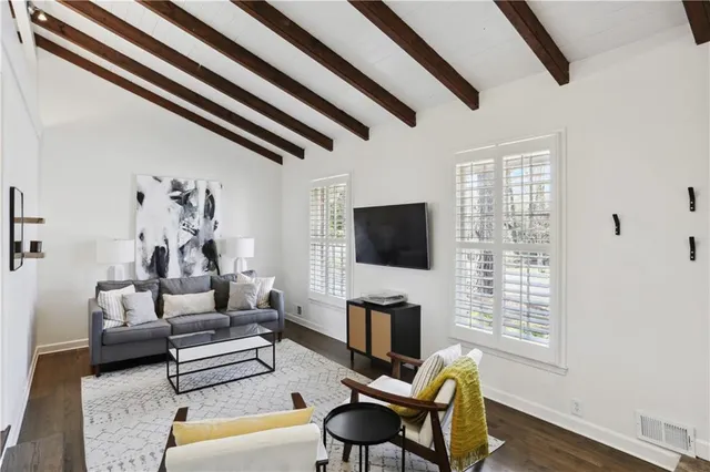 a view of hall way with furniture and stairs