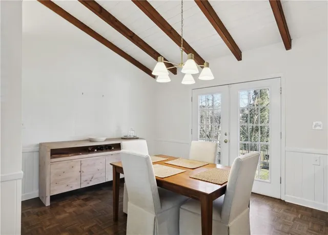 a kitchen with stainless steel appliances a white refrigerator a stove a microwave oven a sink with island and chairs