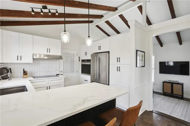 a dining room with a wooden table and chairs