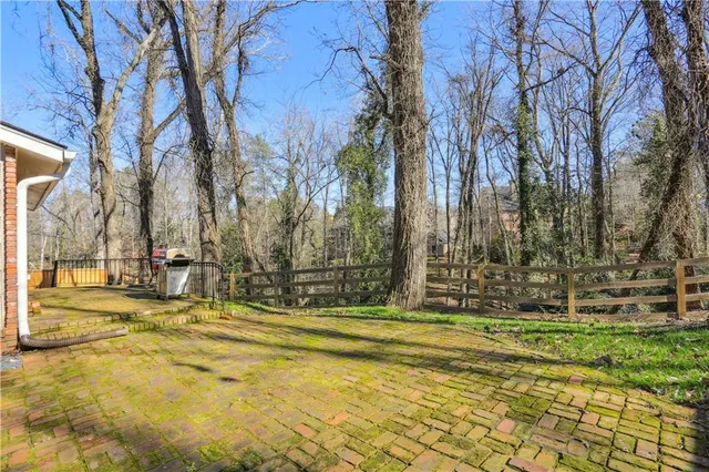 a view of yard with large trees
