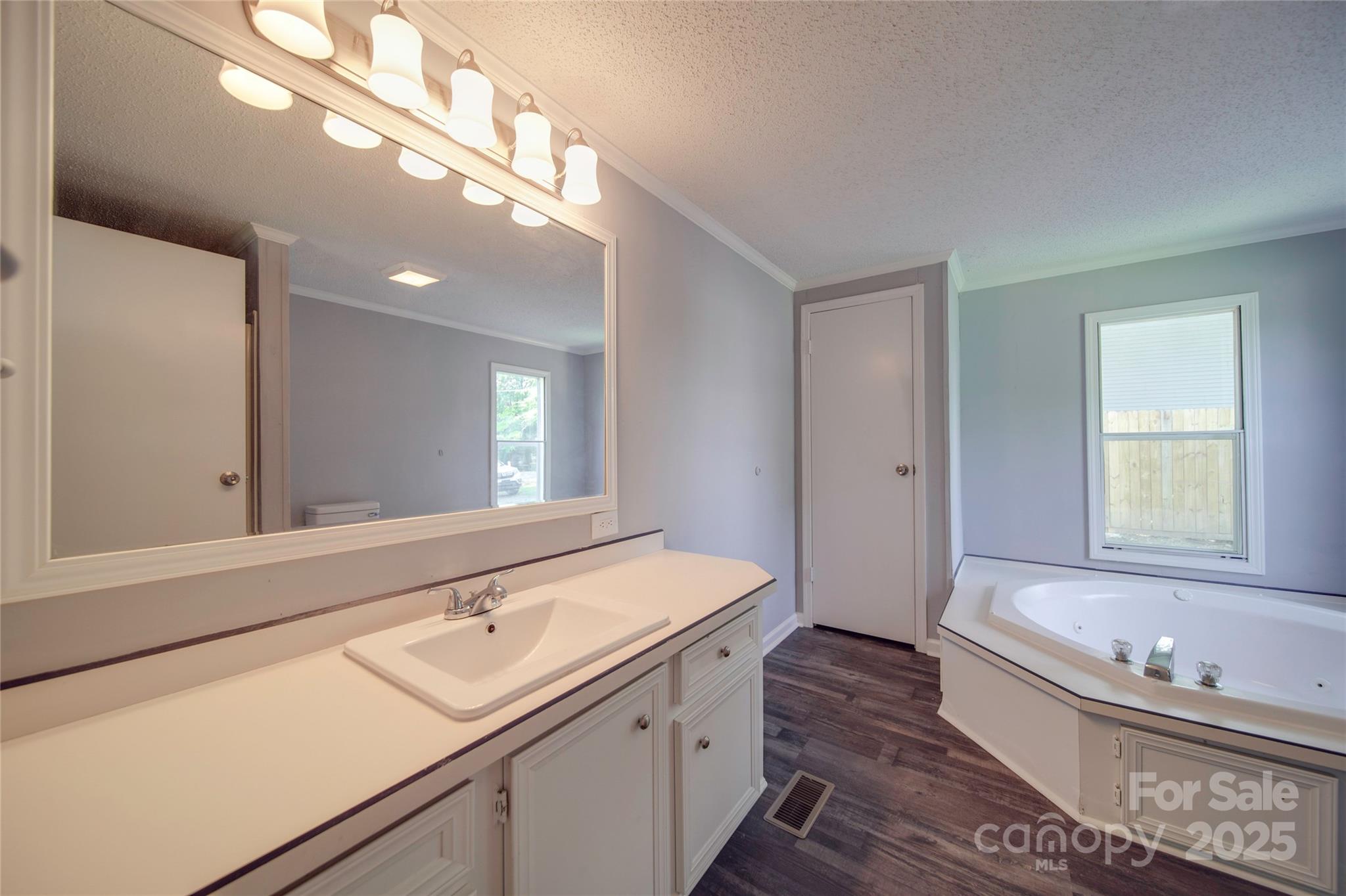 355 Shoreline Road New London, NC 28127 - Photo 11 of 22 a bathroom with a tub a sink and a large mirror
