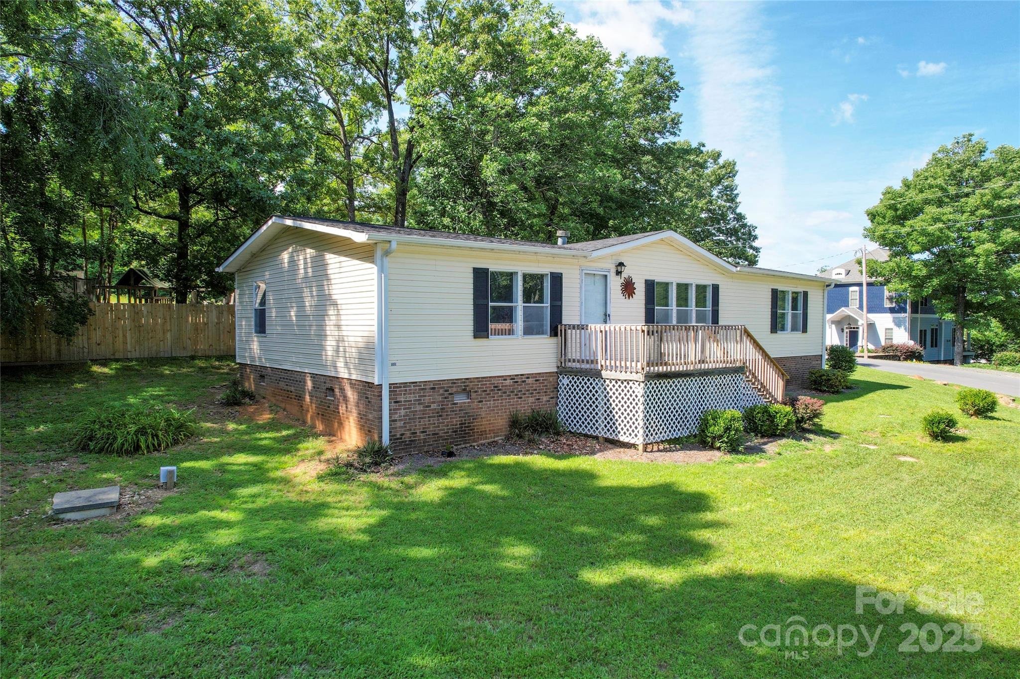 355 Shoreline Road New London, NC 28127 - Photo 2 of 22 a view of a house with a yard and large trees