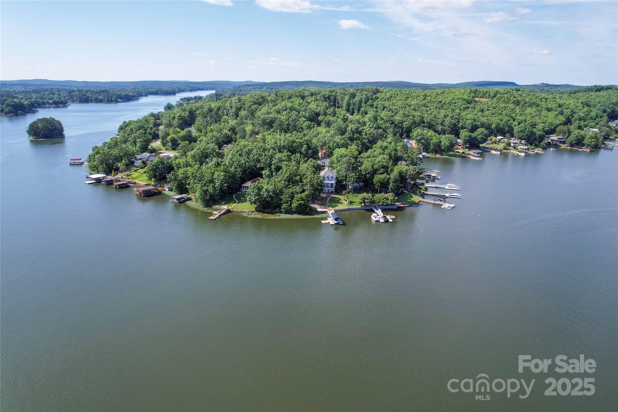 355 Shoreline Road New London, NC 28127 - Photo 21 of 22 an aerial view of a house with a yard and lake view