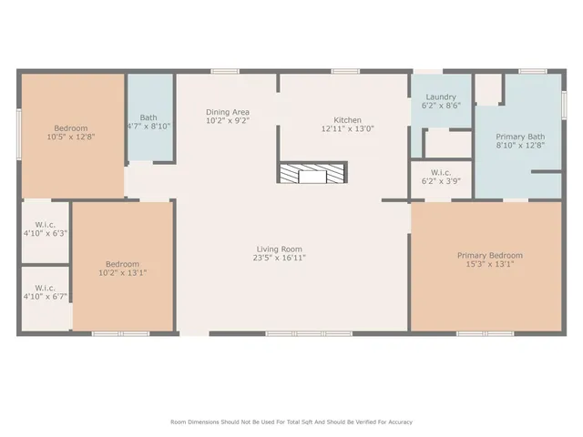 an empty room with wooden floor fireplace and windows