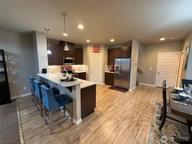 a kitchen with a sink cabinets and wooden floor