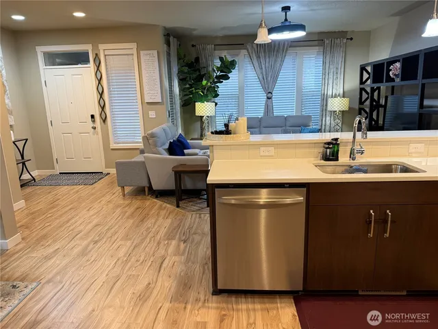 a kitchen with kitchen island a refrigerator stove and microwave