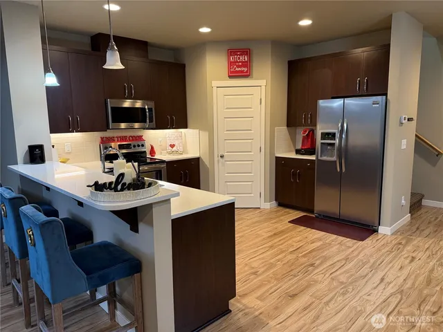 a kitchen with stainless steel appliances granite countertop a sink and a stove top oven