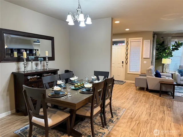 a large kitchen with stainless steel appliances a lot of counter space and a wooden floors