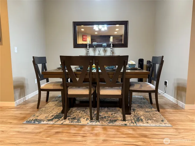 a bathroom with a toilet sink vanity granite and mirror