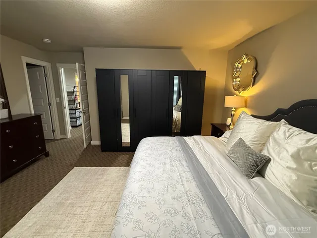 a bedroom with a bed and a mirror