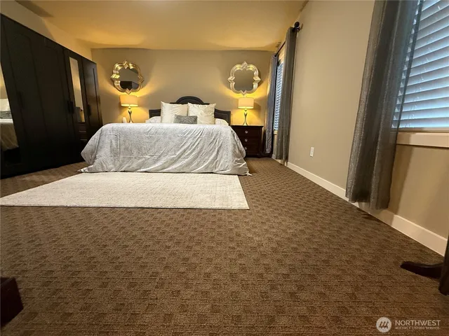 a bed sitting in a bedroom next to a window