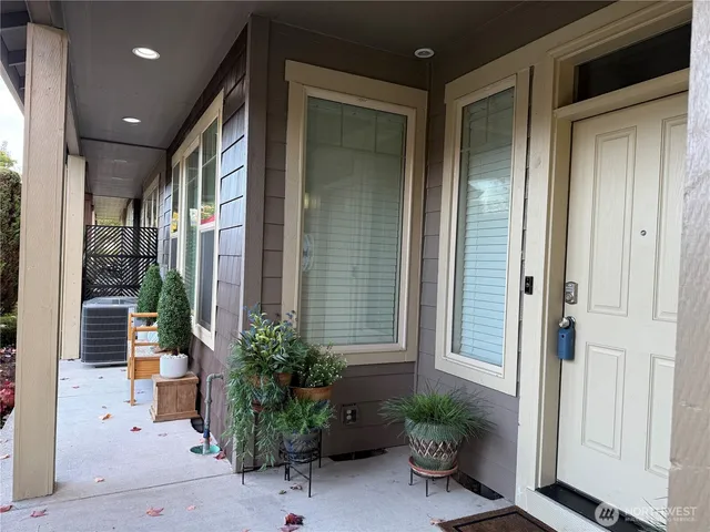 a house with potted plants in front of door