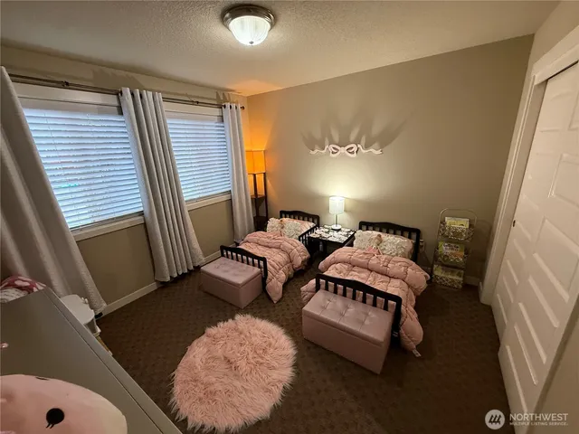 a bedroom with two beds and a chandelier