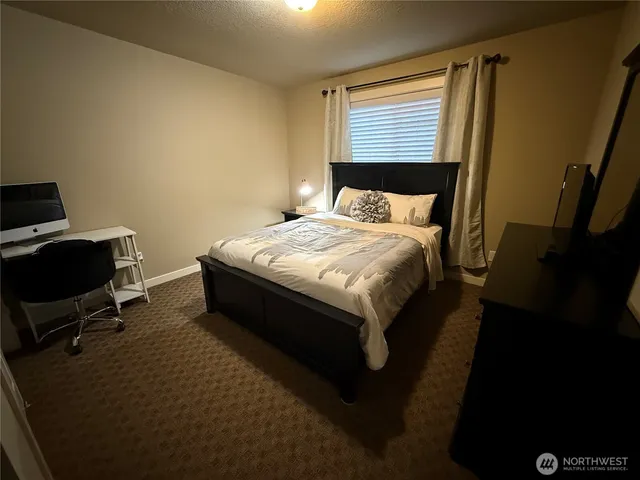 a bedroom with a bed and a mirror