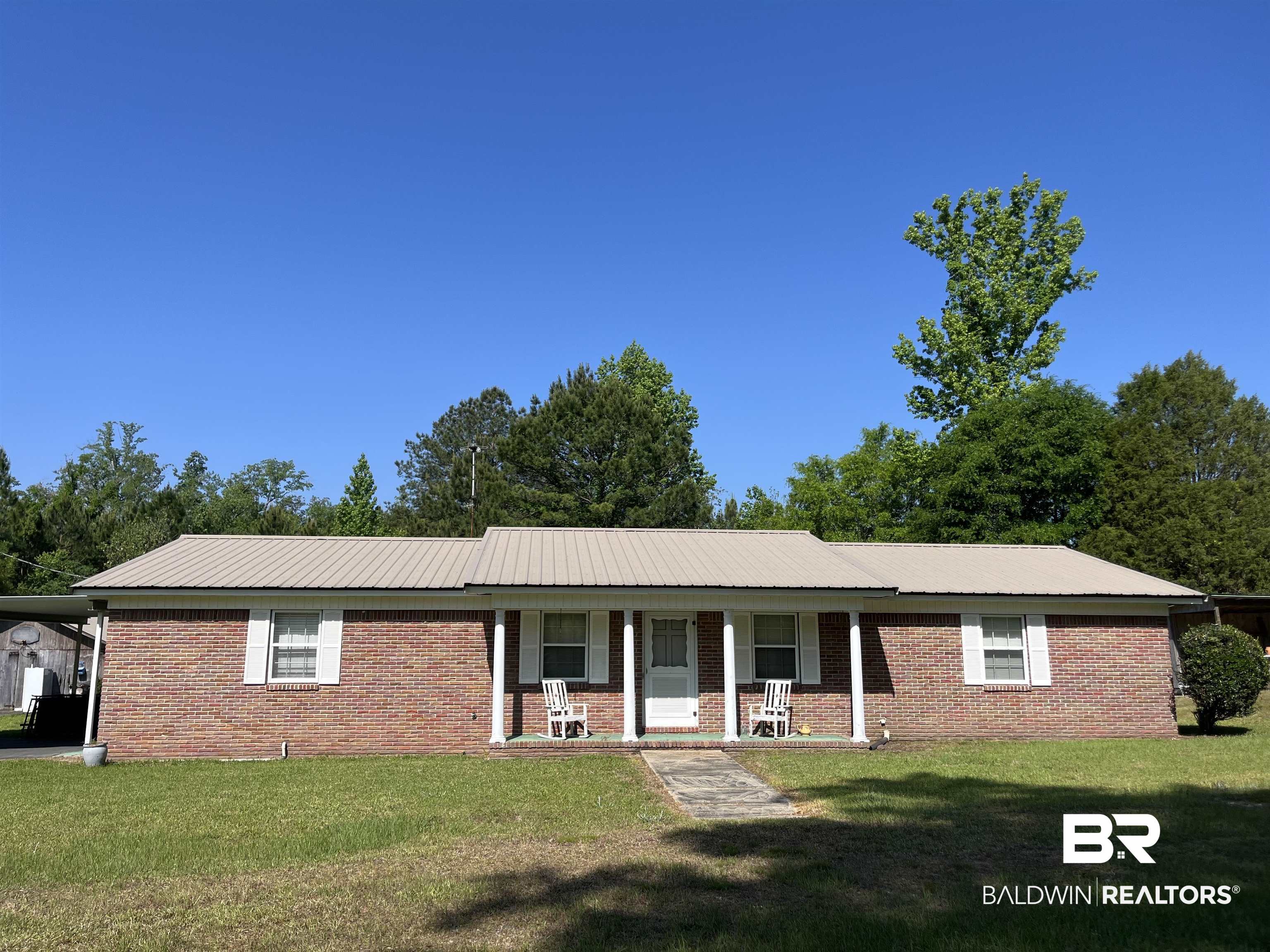 315 Dawkins Road Brewton, AL 36426 - Photo 2 of 19 Ranch-style home with brick siding, a porch, and a front lawn