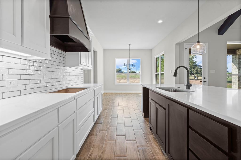 1005 Lilly Lane Weatherford, TX 76088 - Photo 11 of 34 a large kitchen with a sink and cabinets