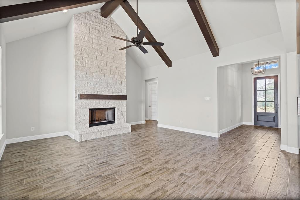 1005 Lilly Lane Weatherford, TX 76088 - Photo 12 of 34 a view of empty room with wooden floor and fireplace