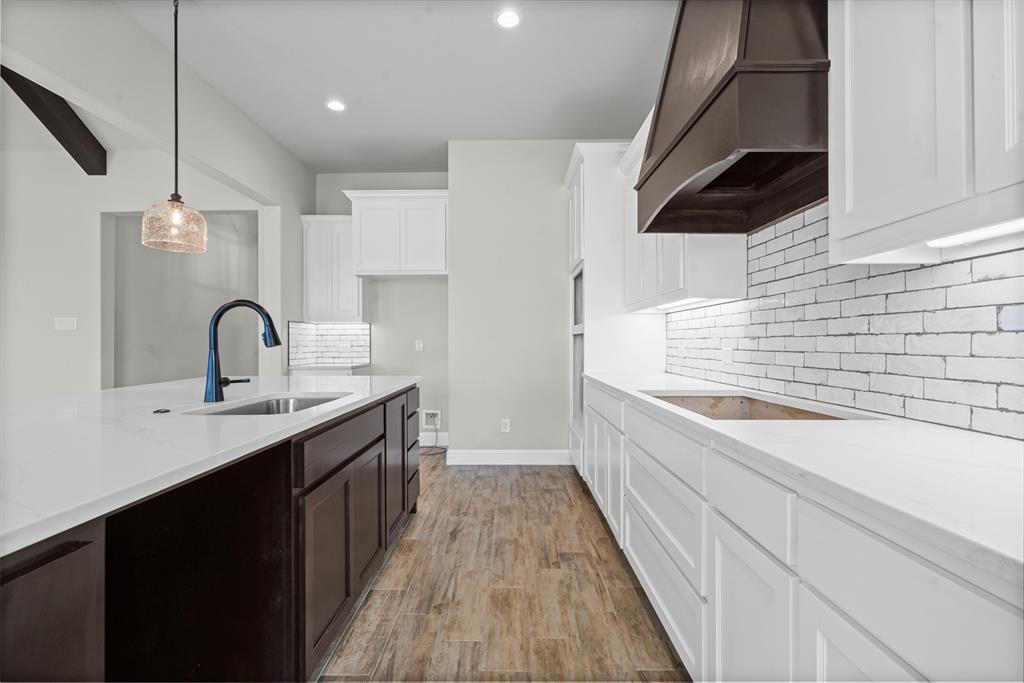 1005 Lilly Lane Weatherford, TX 76088 - Photo 16 of 34 a kitchen with a sink and a stove top oven
