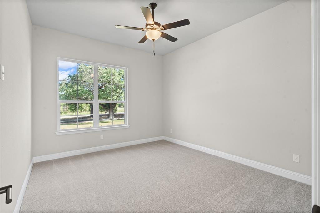 1005 Lilly Lane Weatherford, TX 76088 - Photo 29 of 34 an empty room with a window and a fan
