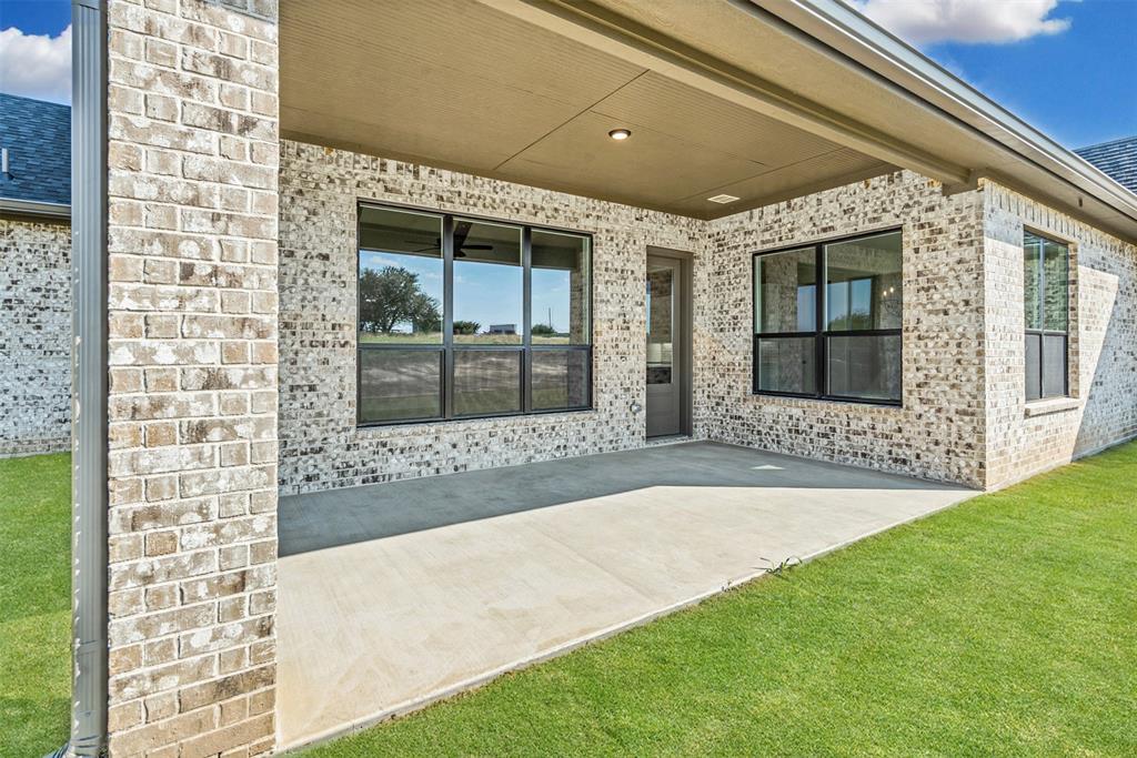 1005 Lilly Lane Weatherford, TX 76088 - Photo 30 of 34 a front view of a house with a garden
