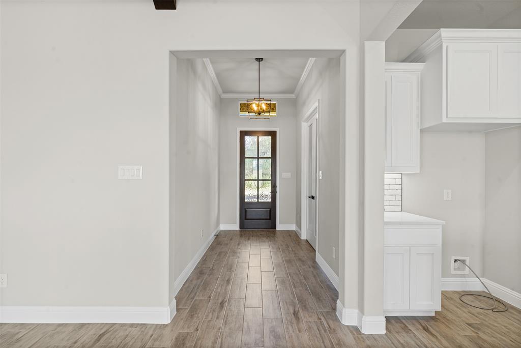 1005 Lilly Lane Weatherford, TX 76088 - Photo 5 of 34 a view of an entryway with wooden floor