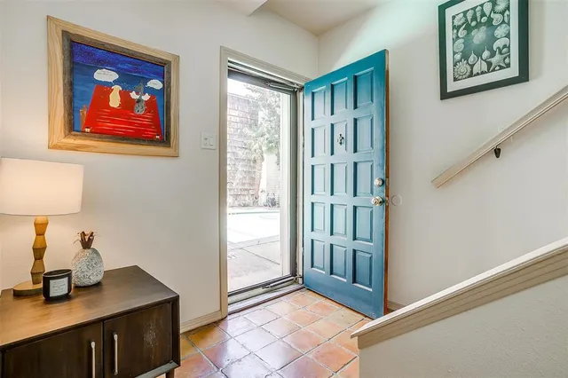 a view of a hallway to rooms and stairs