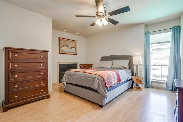 a spacious bedroom with a bed and a chandelier