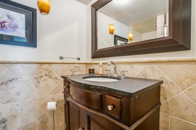 a utility room with a sink and a mirror