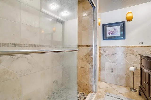 a bathroom with a shower and a sink