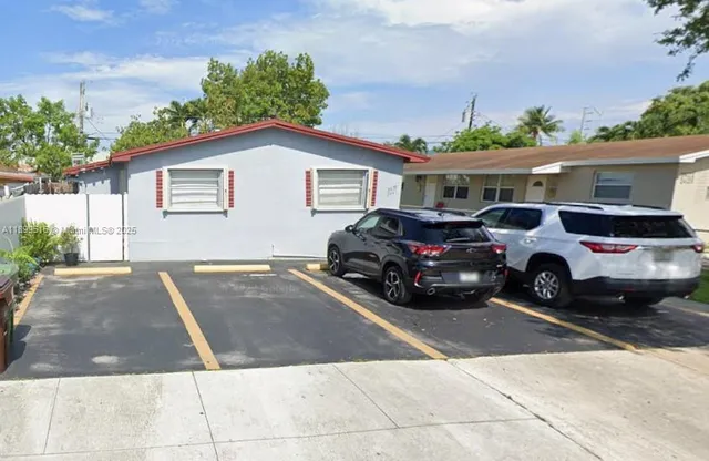 a view of a car parked in front of a house