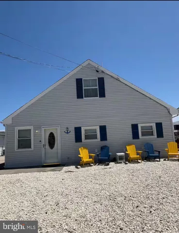 a backyard of a house with barbeque oven table and chairs