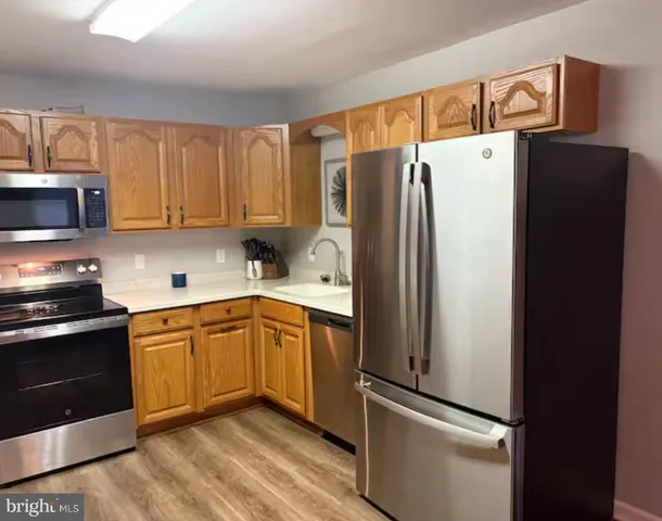 a kitchen with stainless steel appliances a refrigerator and a stove top oven