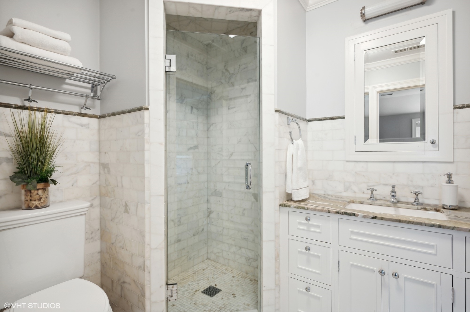 325 Richmond Road Kenilworth, IL 60043 - Photo 30 of 49 a bathroom with a granite countertop sink toilet a mirror a shower and